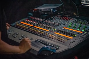 person holding gray and black audio mixer