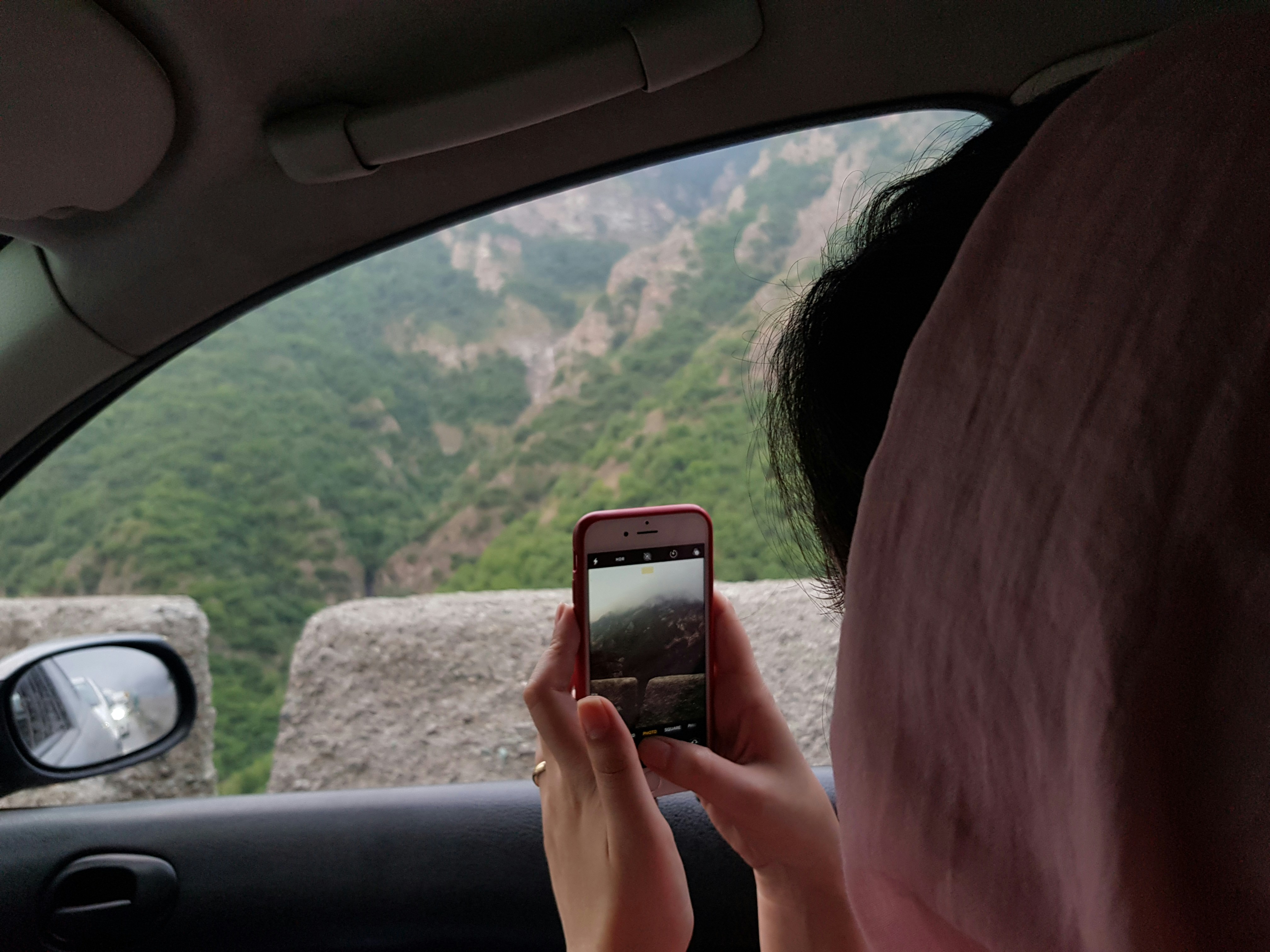 Person holding a phone while watching video content, representing YouTube data usage on mobile