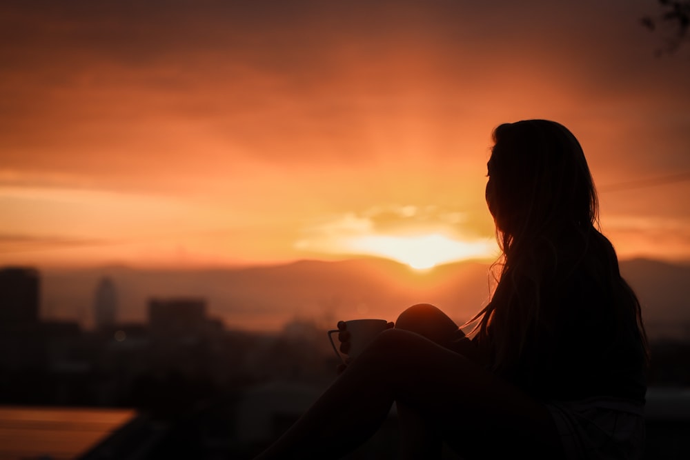 silhouette of woman during sunset