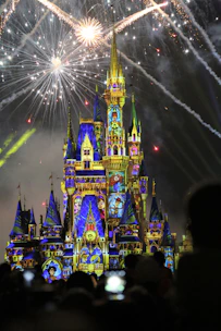 green and blue castle with fireworks during night time