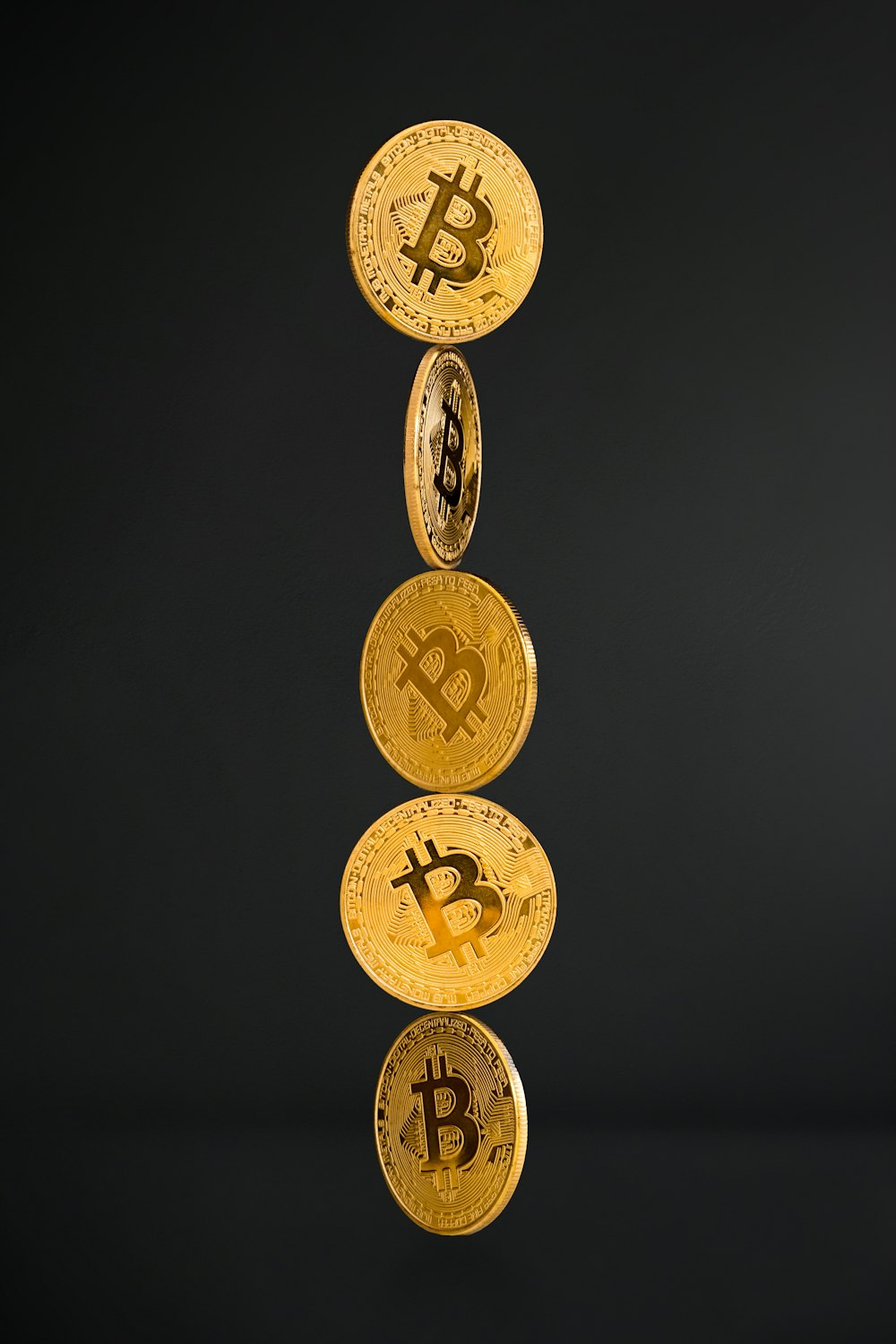 gold round coins on black background