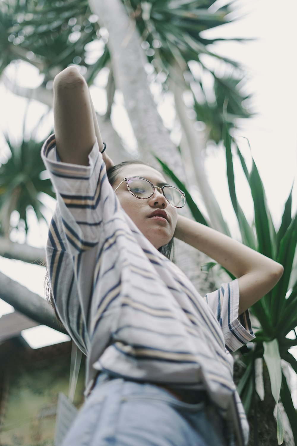 woman in black and white stripe shirt wearing black framed eyeglasses