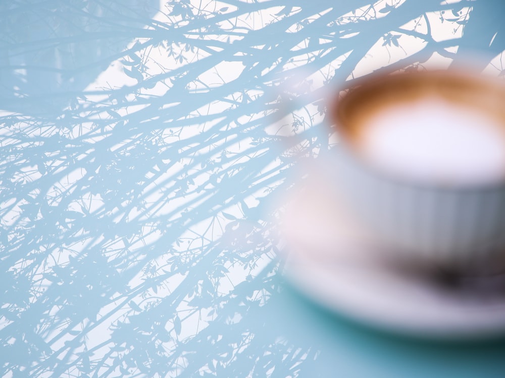 white ceramic mug on white saucer