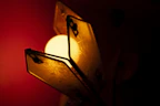 A close-up of a rustic wooden lamp with warm glowing light.