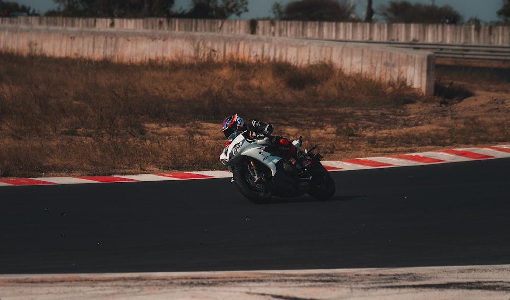 black and white sports bike on track field during daytime