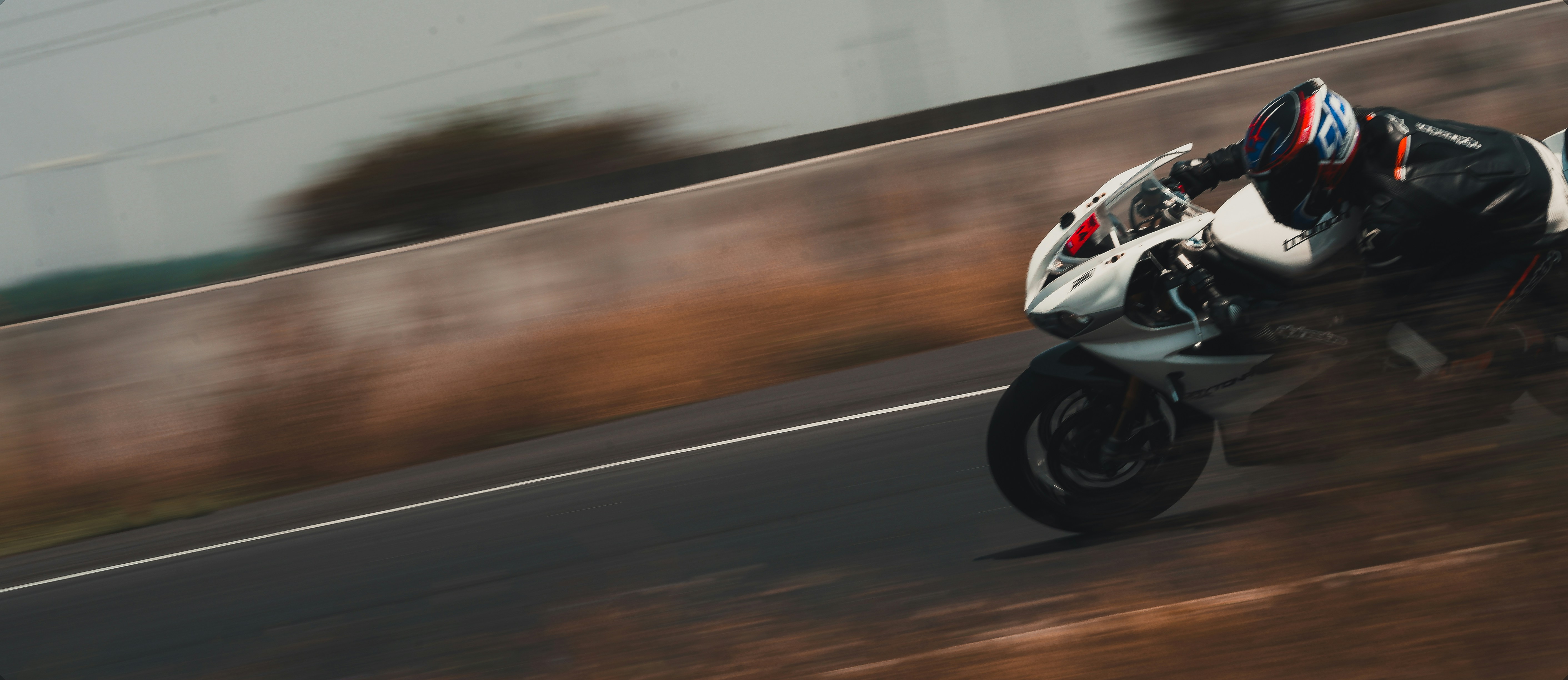 Honda sport motorcycle on race track, low angle, motion blur background, dramatic lighting