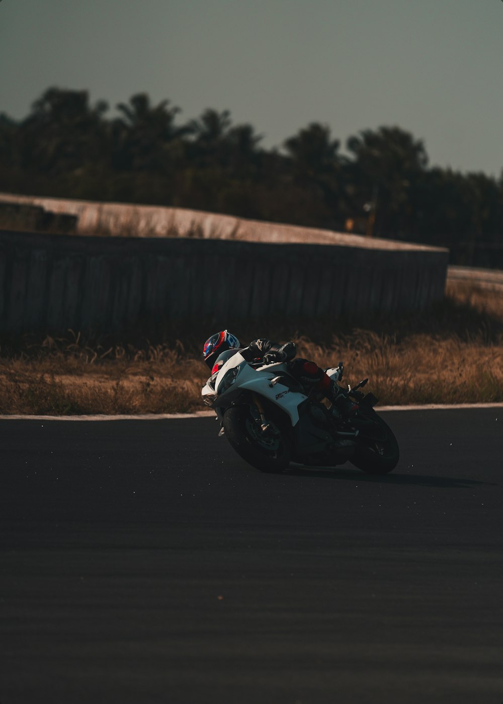 white and black sports bike on road during daytime