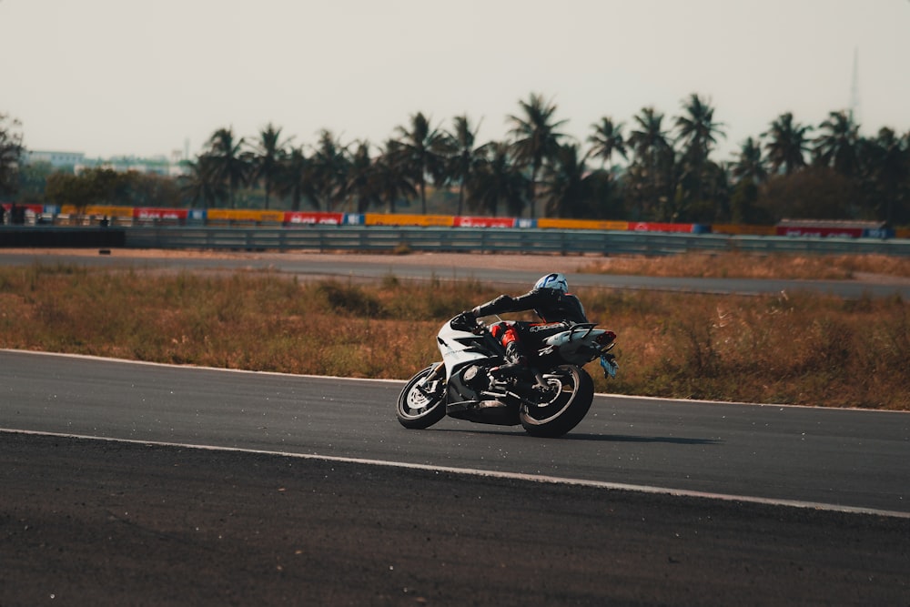 a man riding a motorcycle down a curvy road