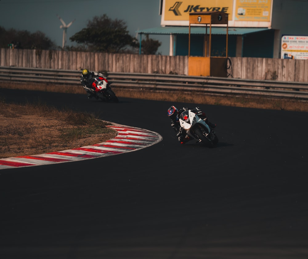 man riding motorcycle on track field during daytime