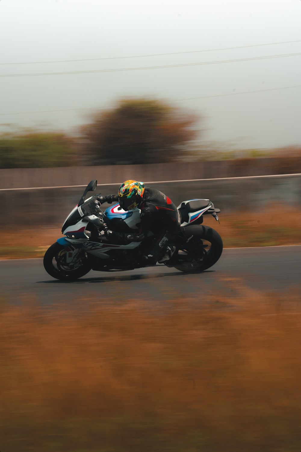 man riding black sports bike on road during daytime