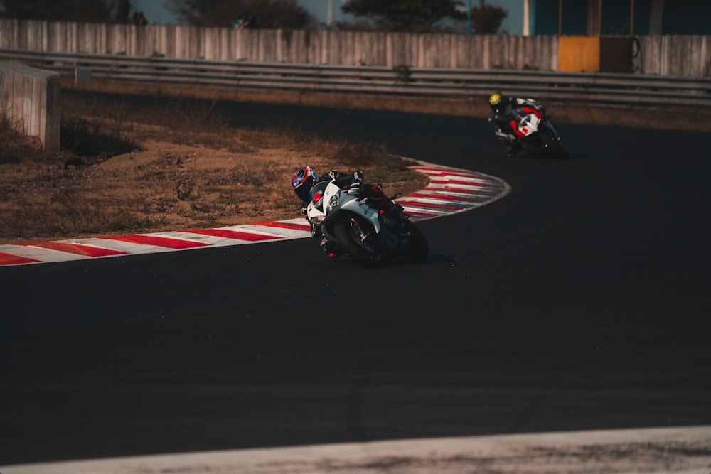 man riding sports bike on track field during daytime