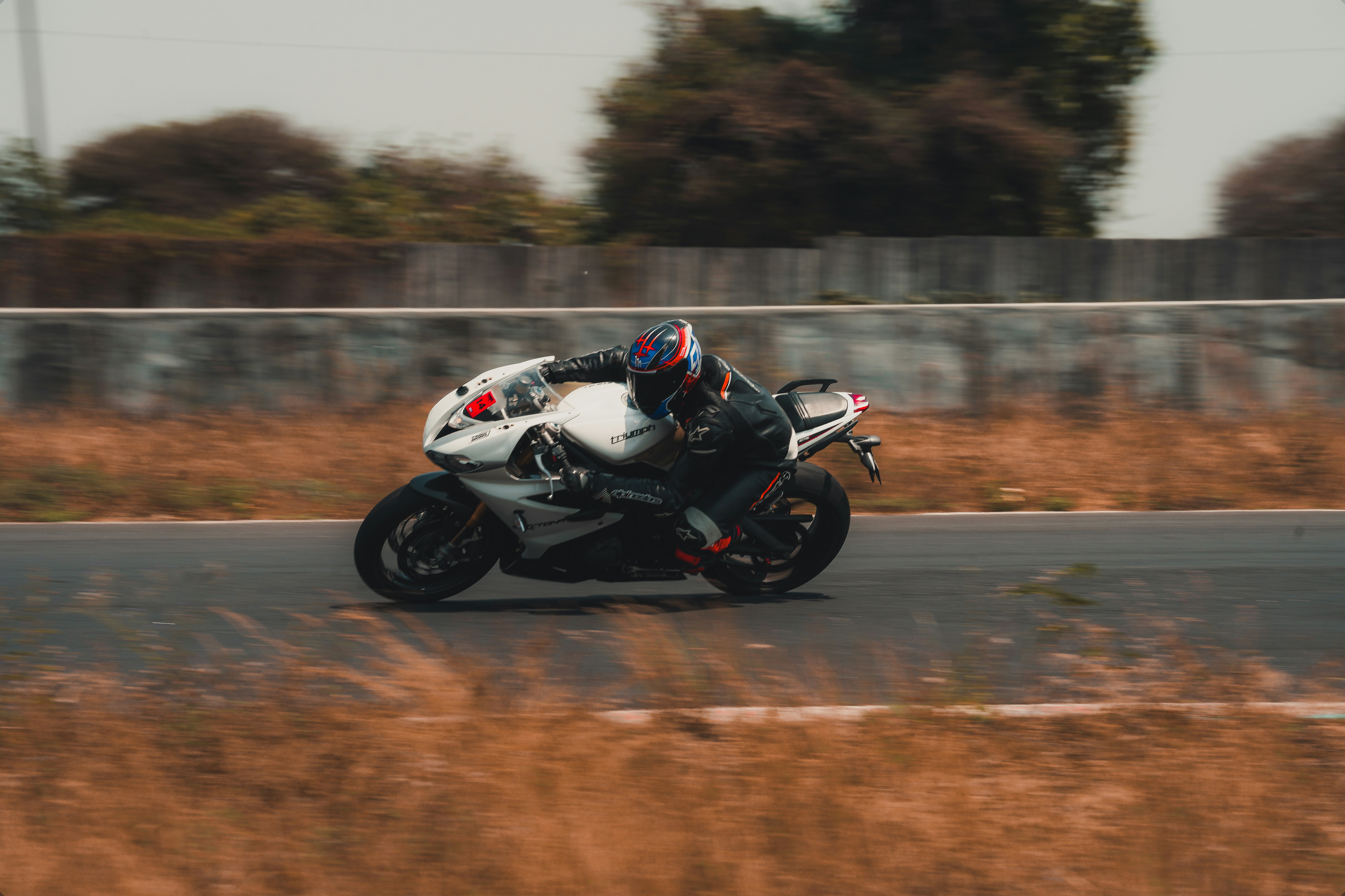 man riding sports bike on road during daytime