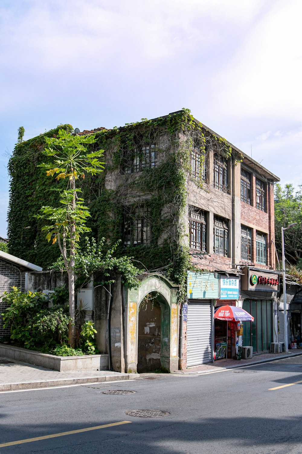 brown concrete building near green trees during daytime