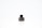 There is a small black bottle with a label that says 'Foellie'. The bottle is placed on a white surface with a light background.