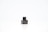 There is a small black bottle with a label that says 'Foellie'. The bottle is placed on a white surface with a light background.