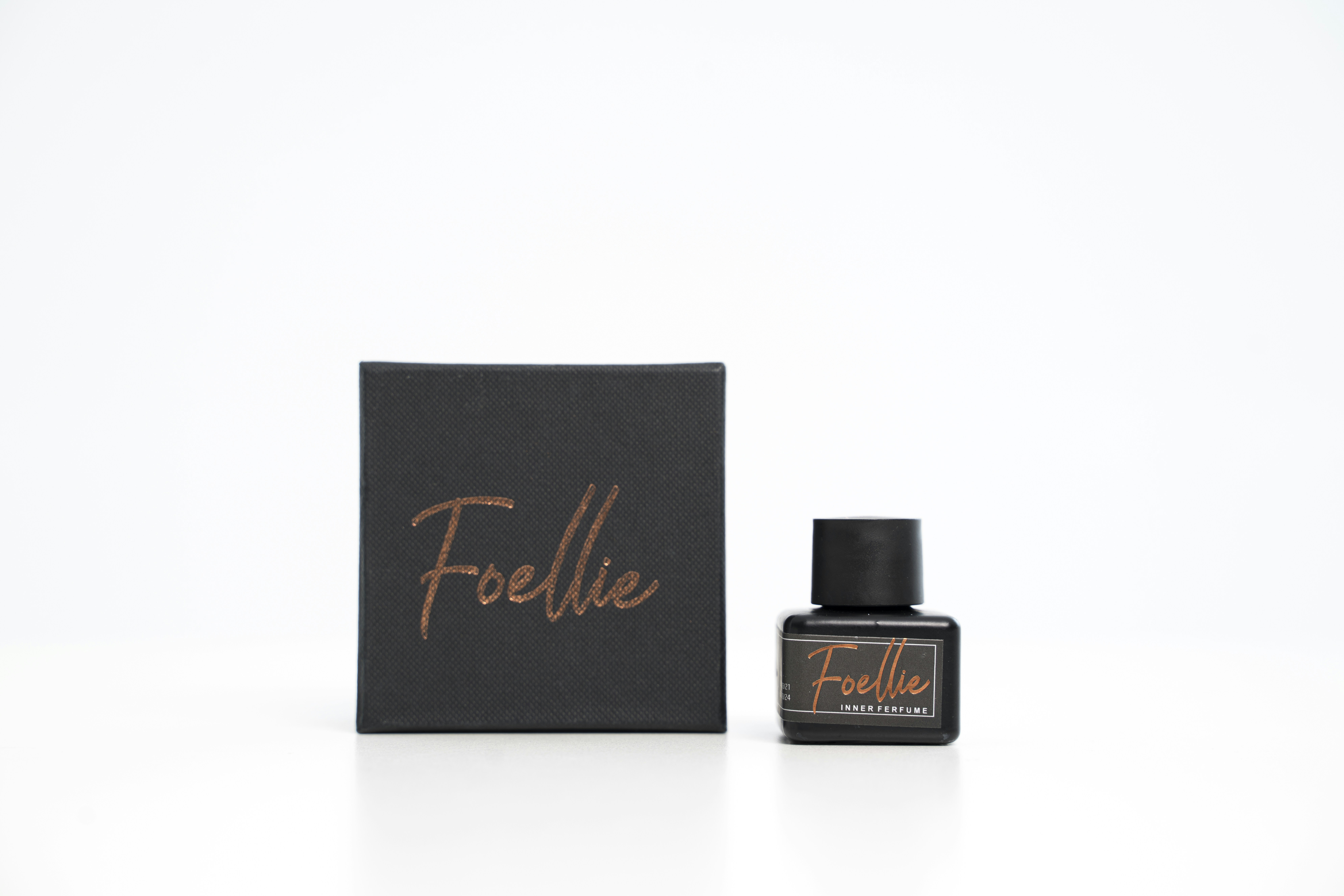 a bottle of perfume sitting next to a box