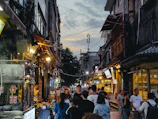 An overhead shot of a bustling Indonesian street food market at twilight.