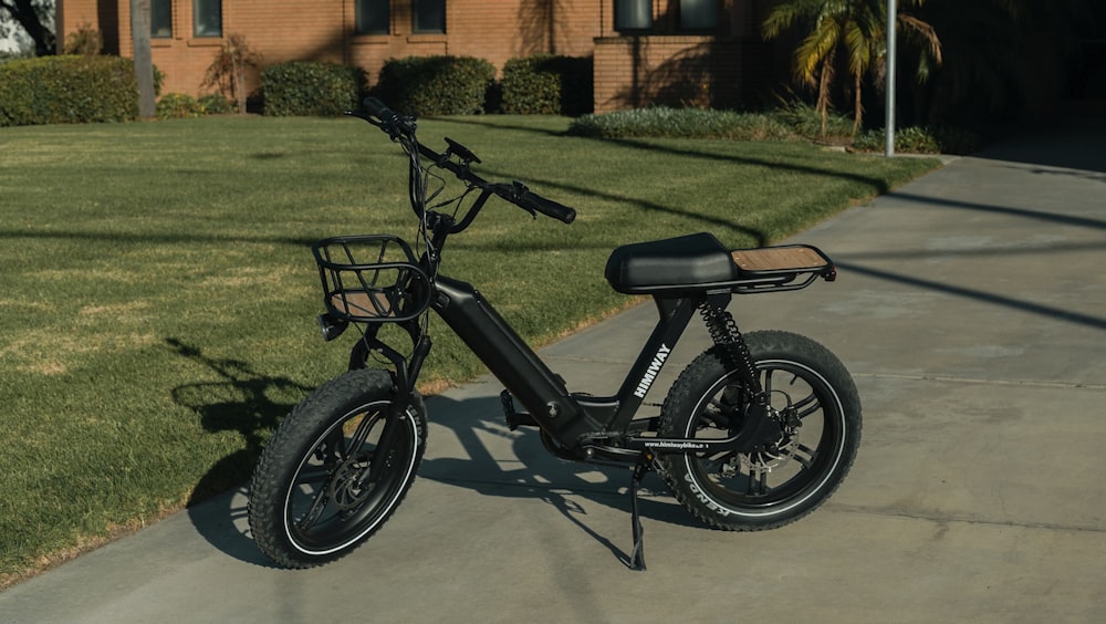 black and gray bicycle on green grass field during daytime