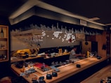 The Roll live sushi bar with chefs preparing artful sushi under soft lighting.