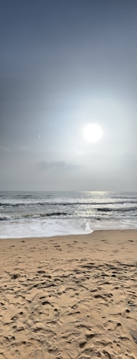 A tranquil beach scene with soft waves and golden sand.