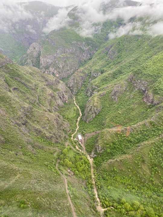 green and gray mountains under white sky during daytime in Tatev Monastery Armenia