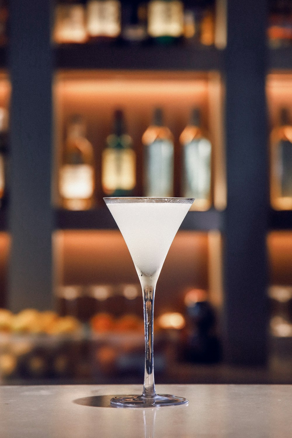 white liquid in clear cocktail glass