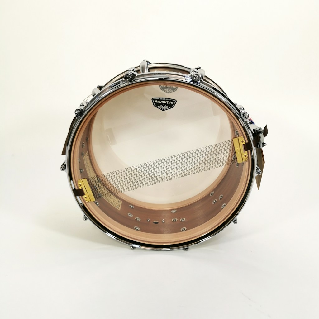 brown and silver drum on white surface
