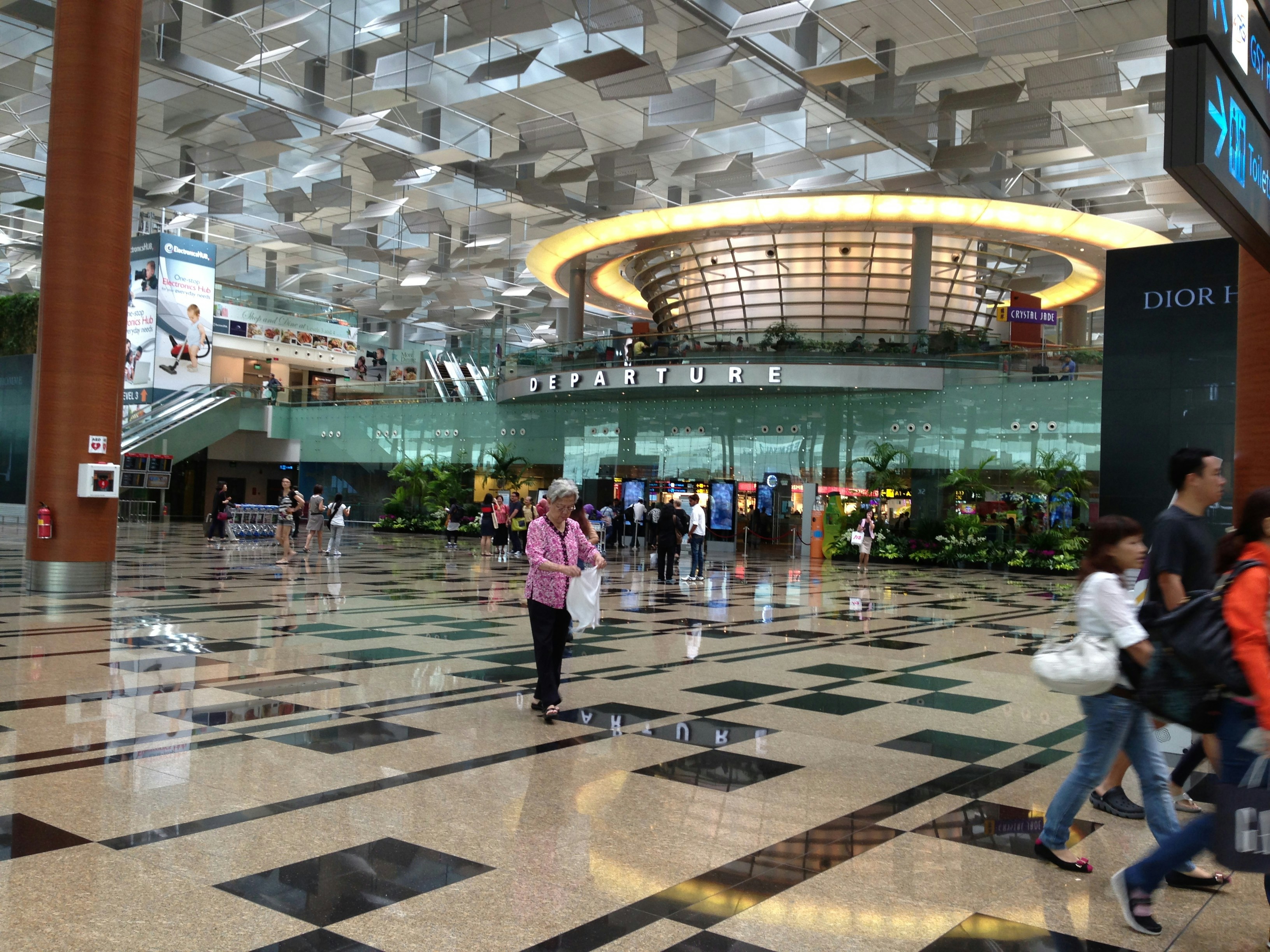 Filipino traveler at bright airport terminal, natural daylight, open airy modern terminal