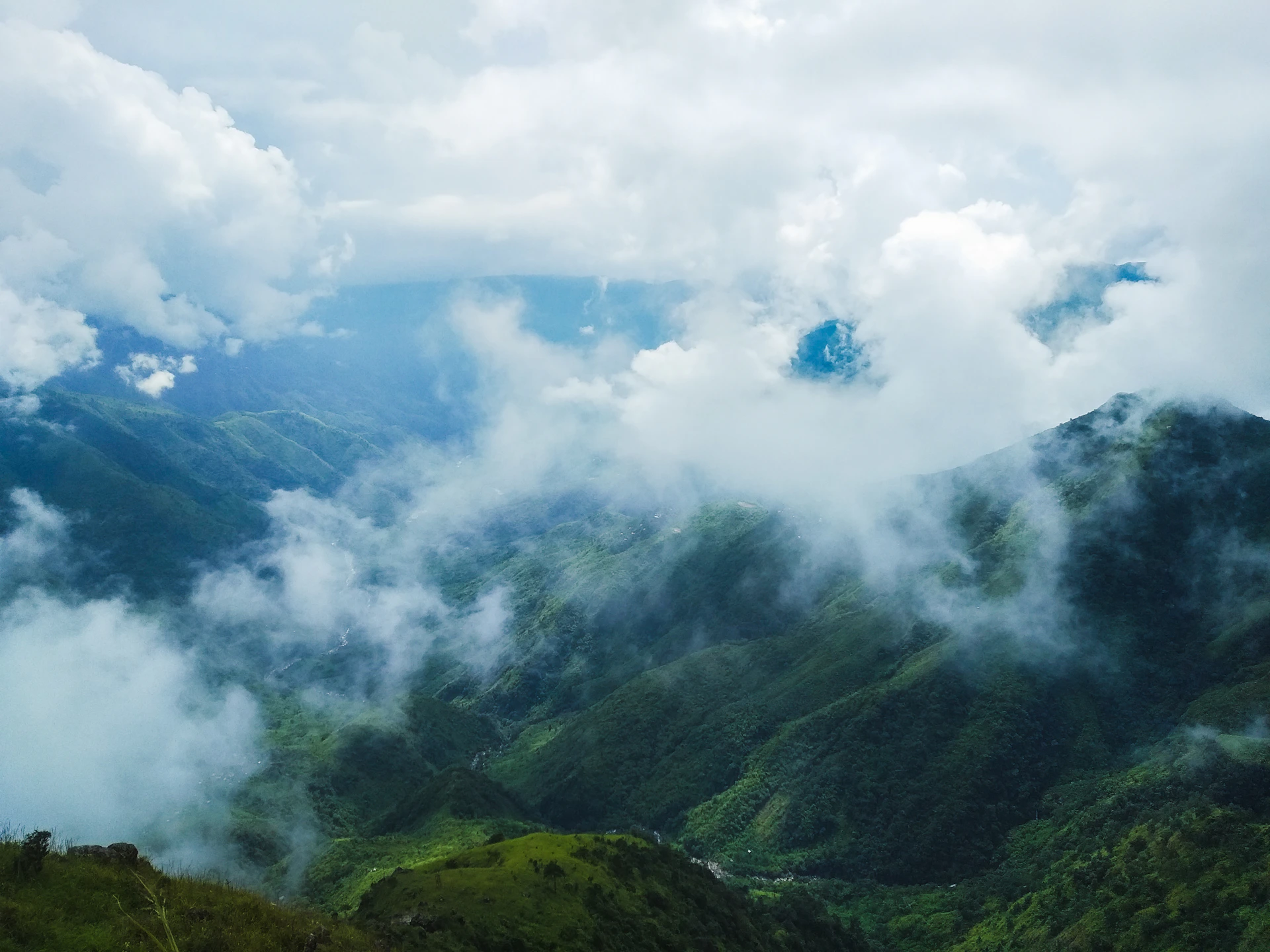 green mountain under white clouds during daytime