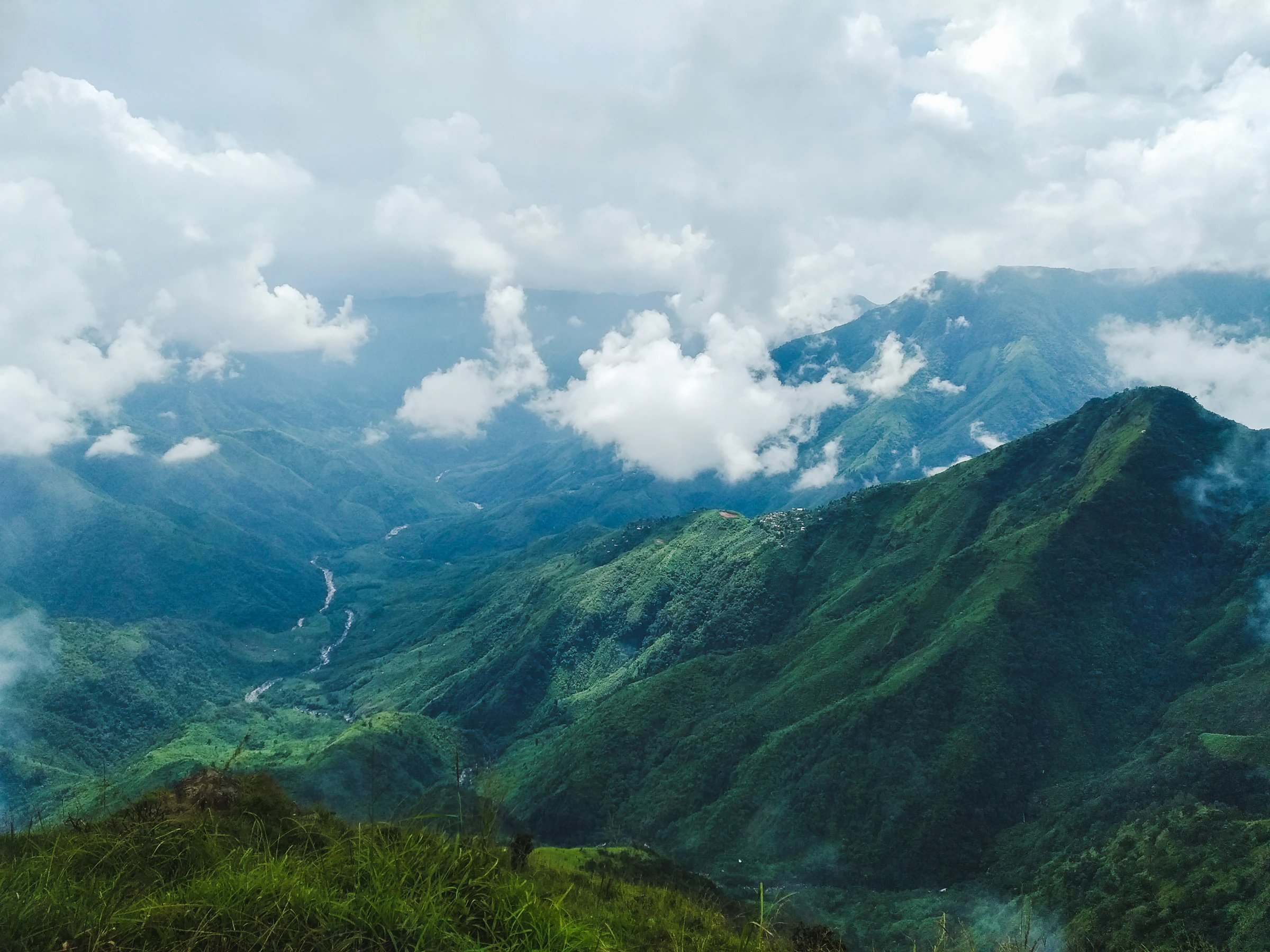 Green hills of Meghalaya under drifting clouds