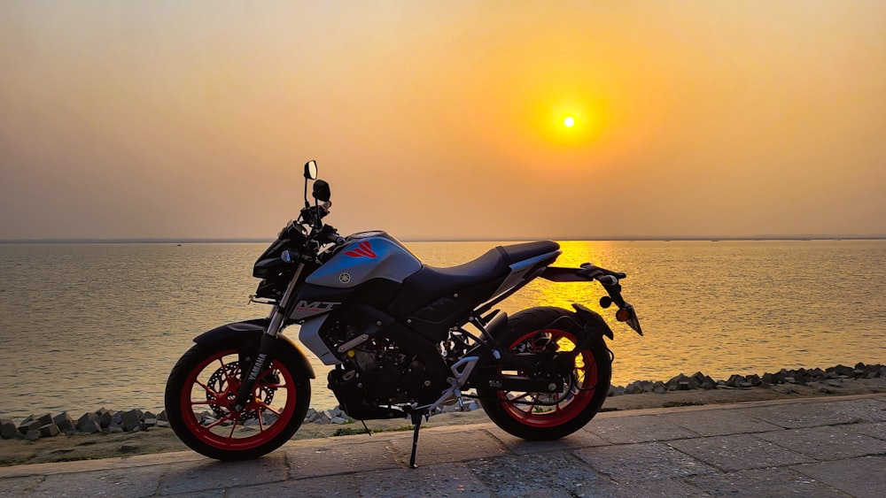 black and red motorcycle on beach during sunset