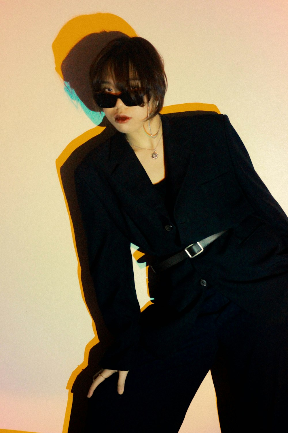woman in black coat wearing black sunglasses