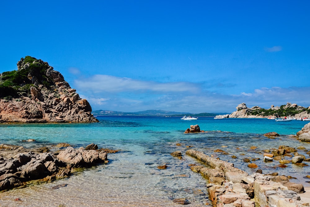 brown rock formation on blue sea under blue sky during daytime