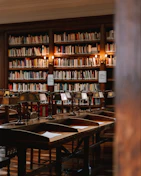 A welcoming study space with books, a laptop, and a cozy lamp inviting students to reach out.