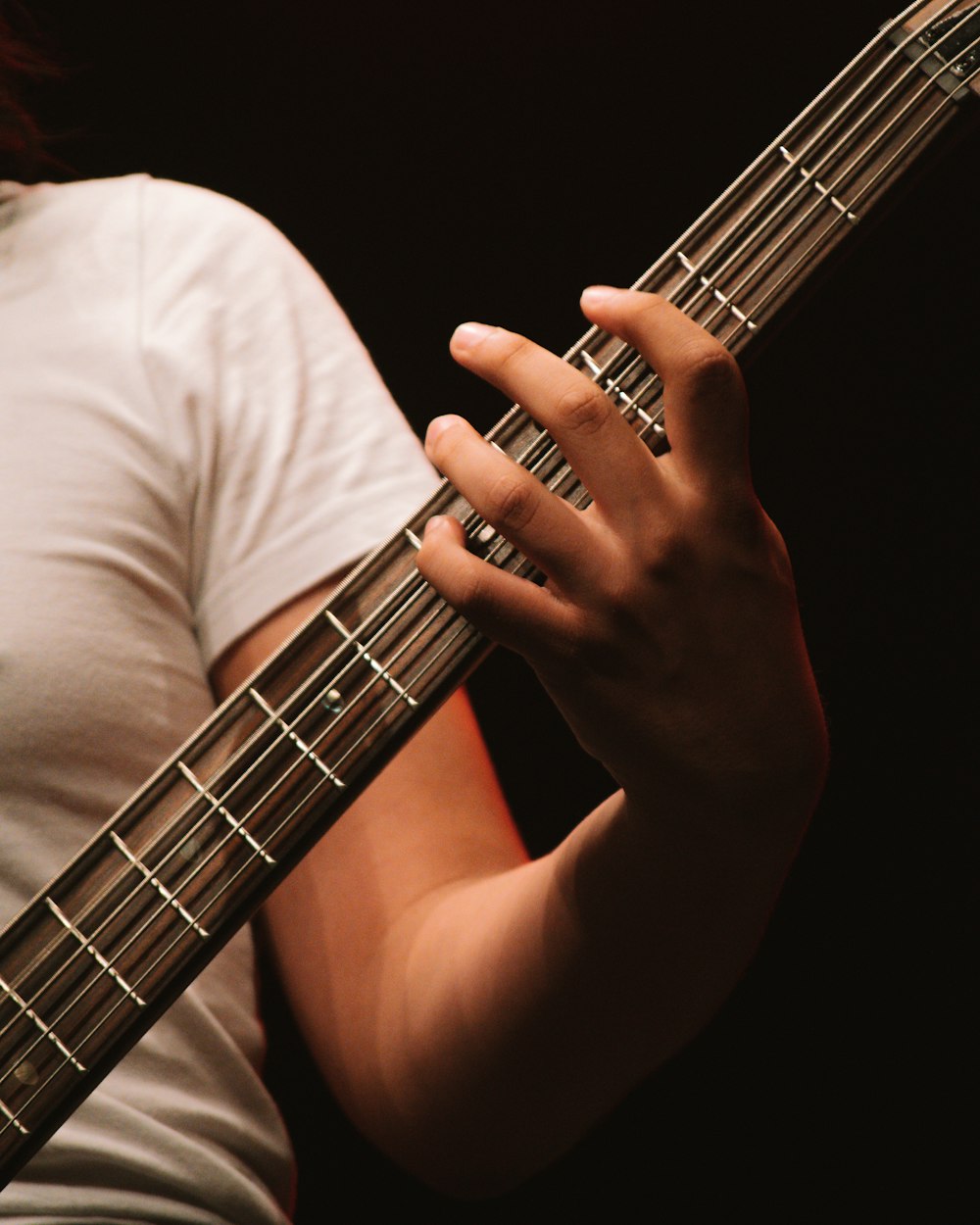 grayscale photo of person playing guitar