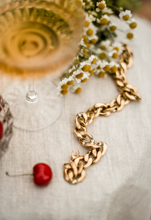 Artistic shot of a luxurious gold chain necklace resting on rich velvet fabric
