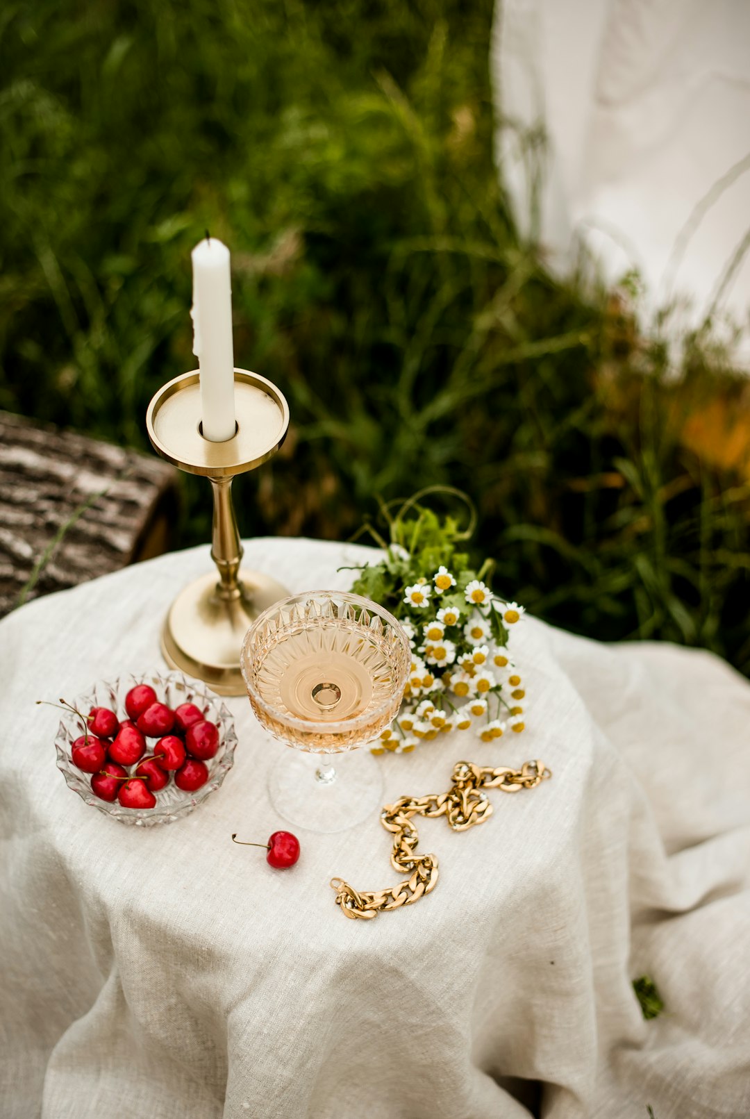 gold and white candle holder on white textile