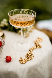 A glass of amber kirschwasser catching the light on a wooden table