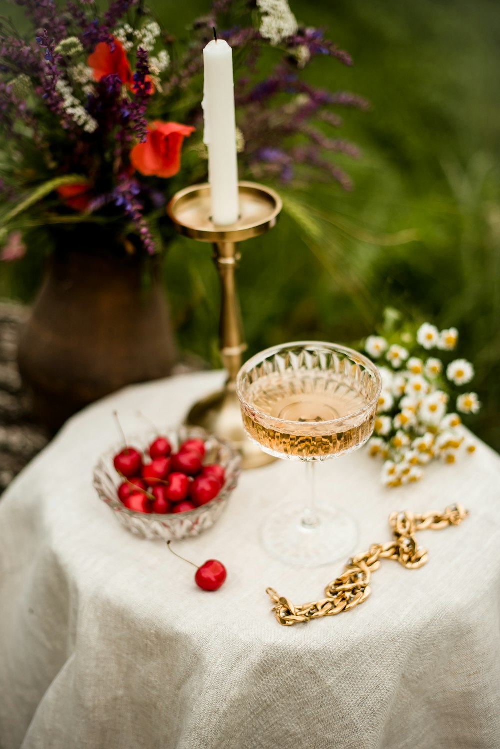 gold and white candle holder on white table cloth