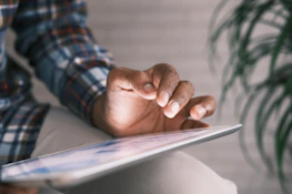 Close-up of a hand interacting with a digital legal intake form on a tablet screen.