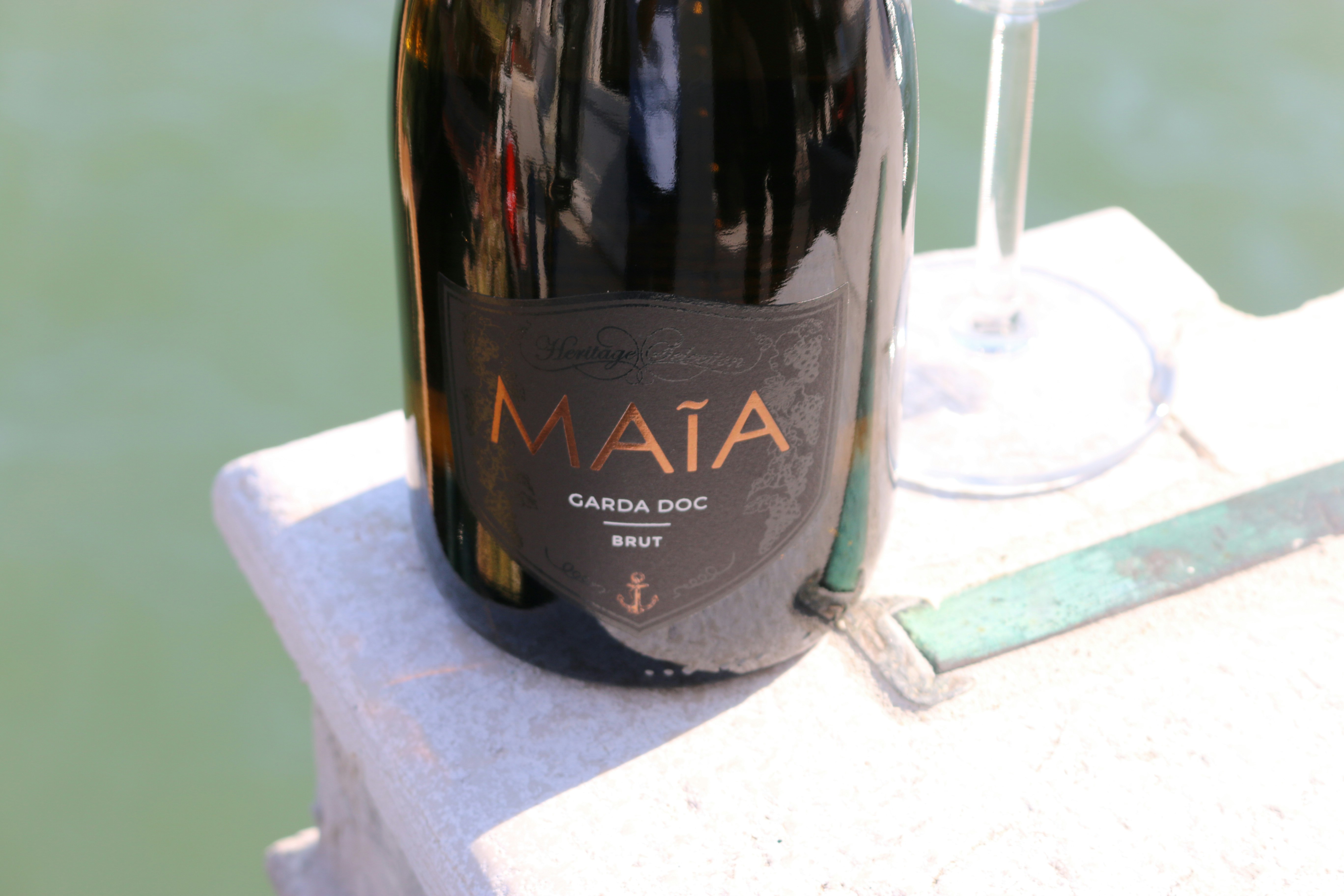 a bottle of wine sitting next to a glass of wine