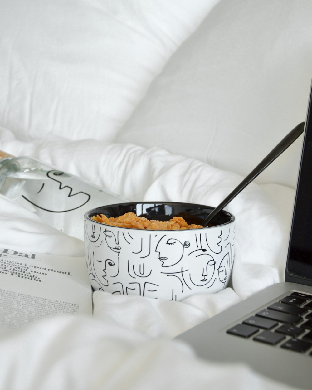 white and black ceramic mug with spoon