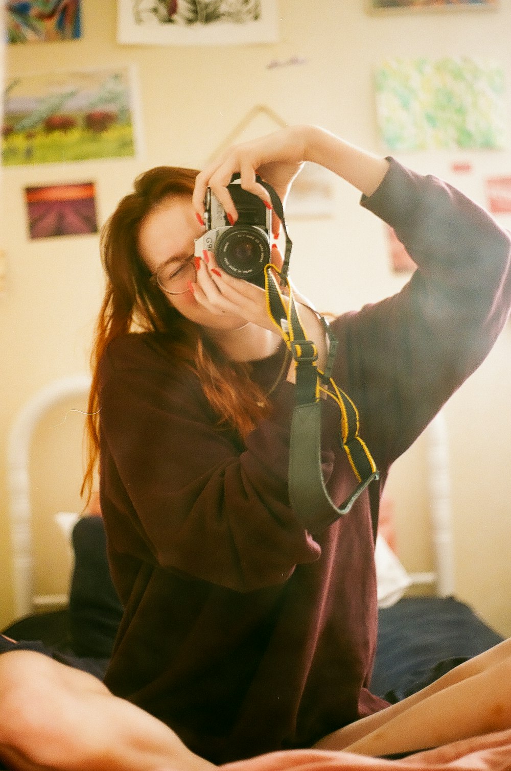 woman in gray long sleeve shirt holding black and silver camera