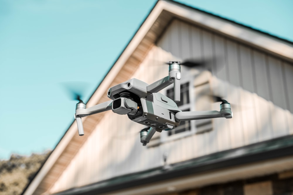 gray and black drone on mid air during daytime