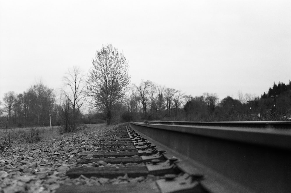 grayscale photo of train rail