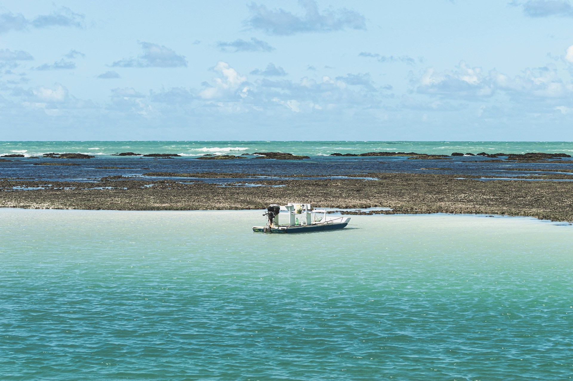white boat on sea during daytime