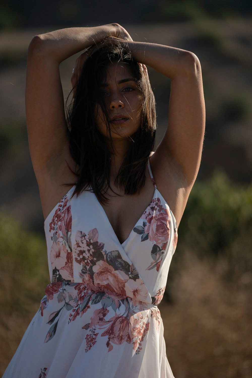 woman in white red and blue floral spaghetti strap top