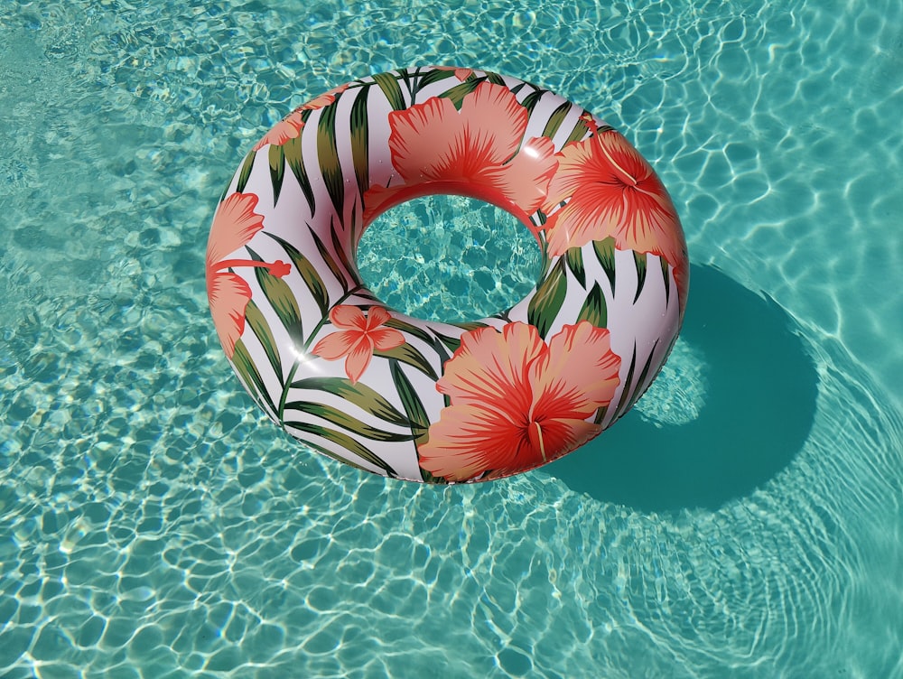 pink and white inflatable ring on green surface