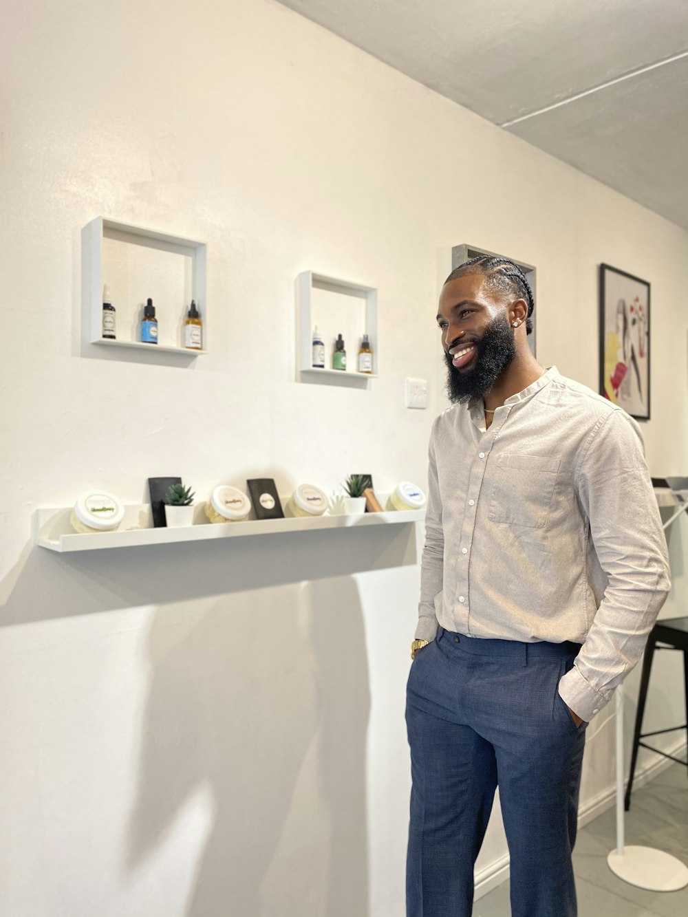 man in white dress shirt standing near white wall