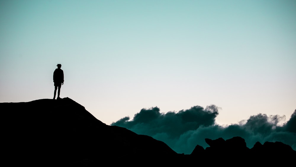 silhouette of mountain under white clouds during daytime